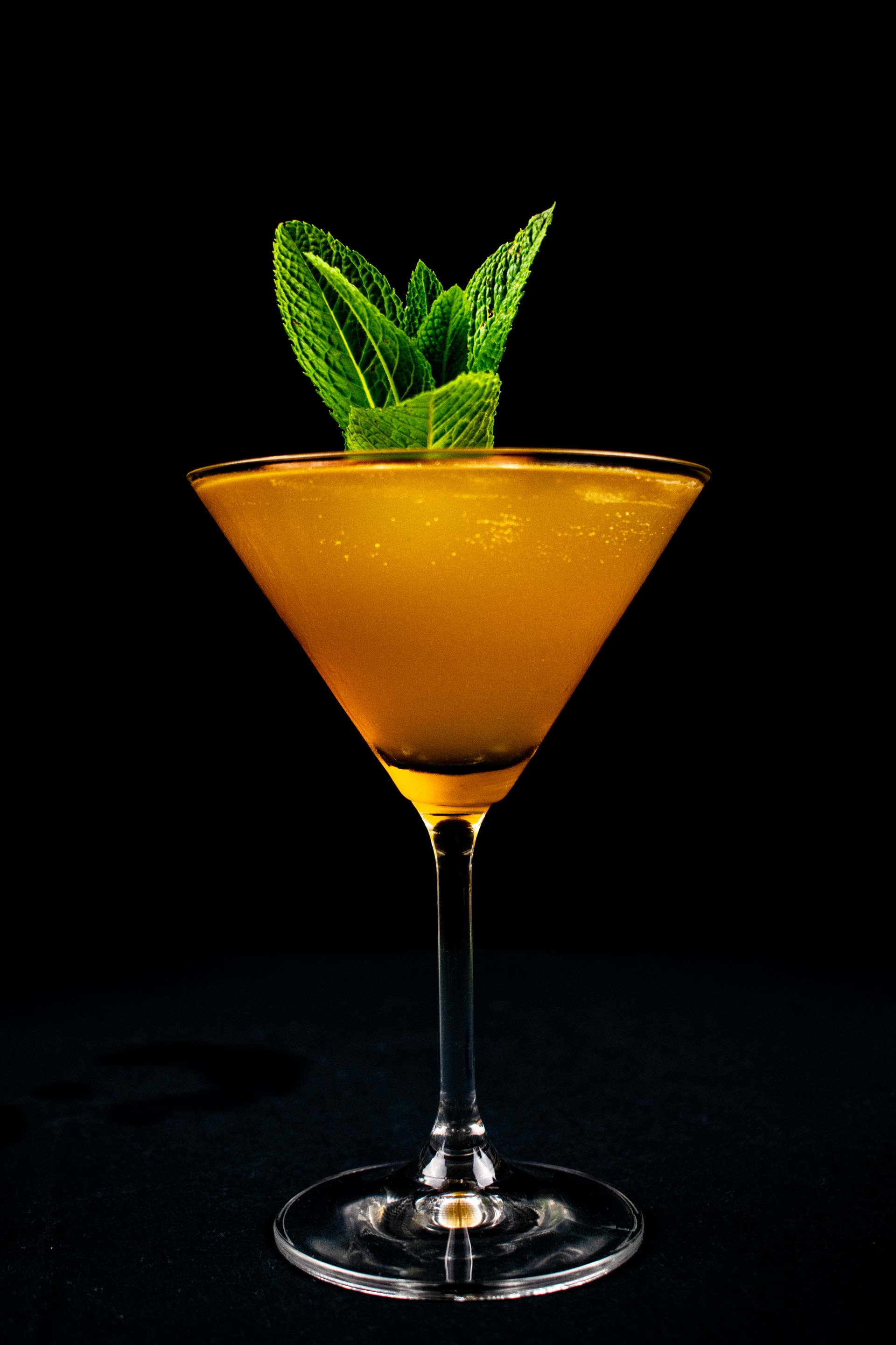 orange liquid in clear cocktail glass